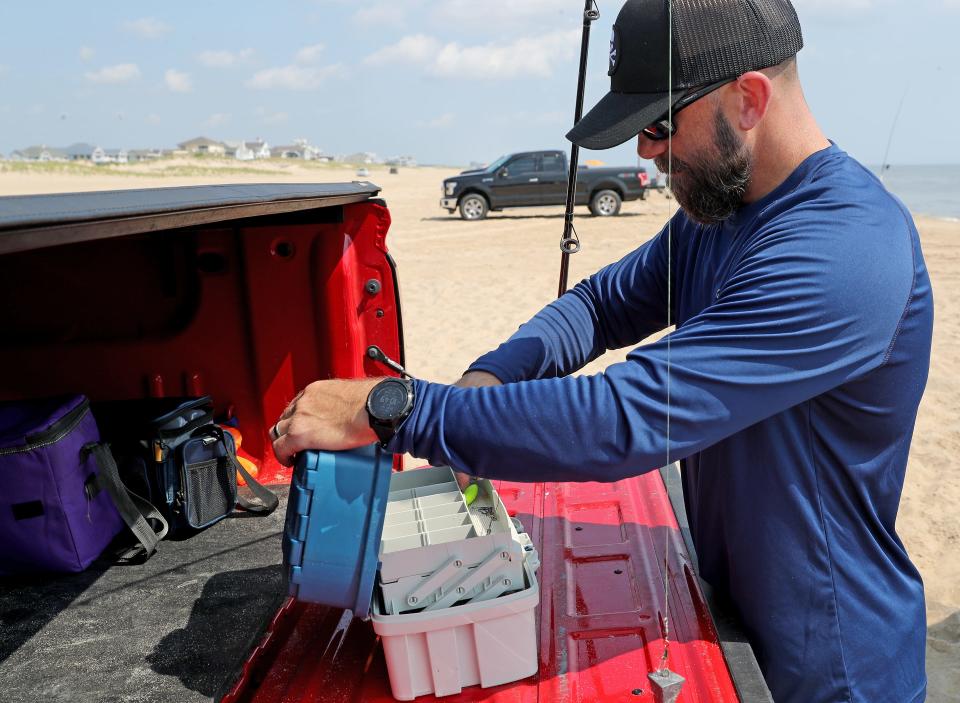 Bruce Werkheiser sets up his fishing pole Friday, July 16, 2021, on Fenwick Island State Park in Fenwick Island, Delaware.