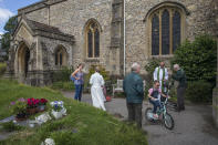 The Rev. Jonathan Gordon, second right, and Assistant Vicar Miranda Sheldon, second left, greet Anglican worshippers who attended their first communal prayer service after pandemic restrictions were eased, at St. Mary's Church in Northchurch, England, on Sunday, July 5, 2020. On March 24, the Church of England closed all its buildings. "It posed an immediate and immense challenge," Gordon says. "It meant that we had to completely rethink how we did everything." (AP Photo/Elizabeth Dalziel)