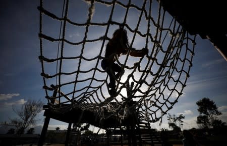 Children play as community members gather in a park to discuss gang violence in Manenberg township, Cape Town