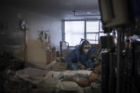 Healthcare workers assist a COVID-19 patient at one of the intensive care units (ICU) of the Germans Trias i Pujol hospital in Badalona, Barcelona province, Spain, Wednesday, April 1, 2020. The new coronavirus causes mild or moderate symptoms for most people, but for some, especially older adults and people with existing health problems, it can cause more severe illness or death. (AP Photo/Felipe Dana)