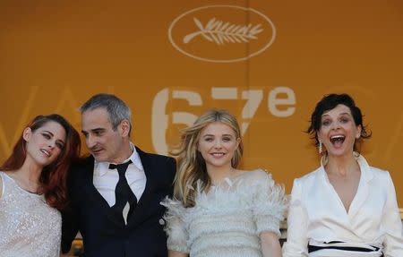 Director Olivier Assayas (2ndL), cast members Kristen Stewart (L), Chloe Grace Moretz (2ndR) and Juliette Binoche (R) pose on the red carpet as they arrive for the screening of the film "Sils Maria" (Clouds of Sils Maria) in competition at the 67th Cannes Film Festival in Cannes May 23, 2014. REUTERS/Regis Duvignau