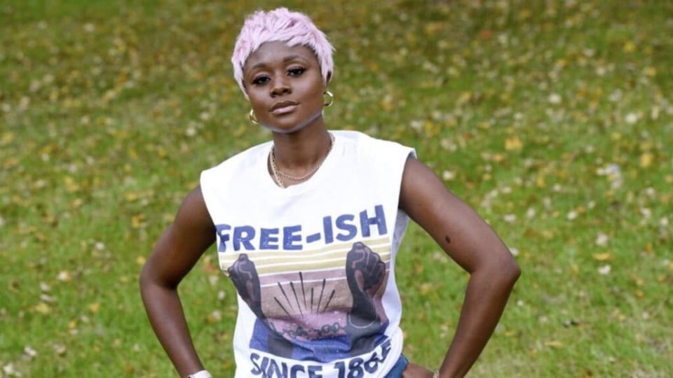 Nigerian American lifestyle blogger Nifesimi Akingbe stands outside her home in Randallstown, Md., near Baltimore, on Sunday, Oct. 11, 2020. (AP Photo/Steve Ruark)