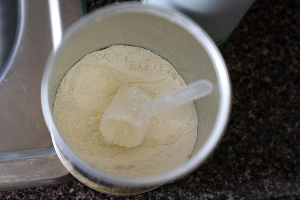 Only a few scoops are left in her next to last can, as Yury Navas, 29, of Laurel, Md., feeds her infant son, Ismael Galvaz, 2 months, with the only formula he can take without digestive issues, Enfamil Infant, from her dwindling supply of formula at their apartment in Laurel, Md., Monday, May 23, 2022. After this day's feedings she will be down to their last 12.5 ounce container of formula. Navas doesn't know why her breastmilk didn't come in for her third baby and has tried many brands of formula before finding the one kind that he could tolerate well, which she now says is practically impossible for her to find. To stretch her last can she will sometimes give the baby the water from cooking rice to sate his hunger. (AP Photo/Jacquelyn Martin)