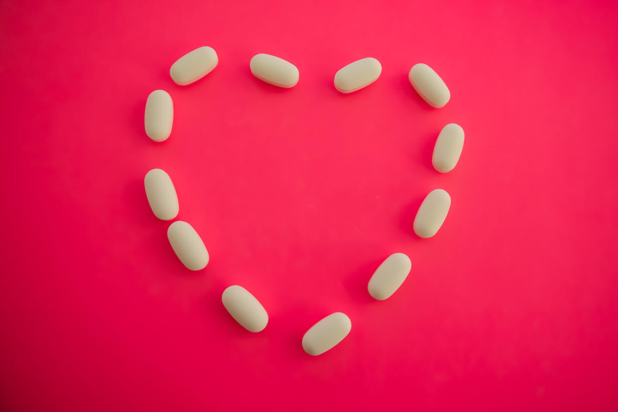 medicinal white prescription pills in shape of heart