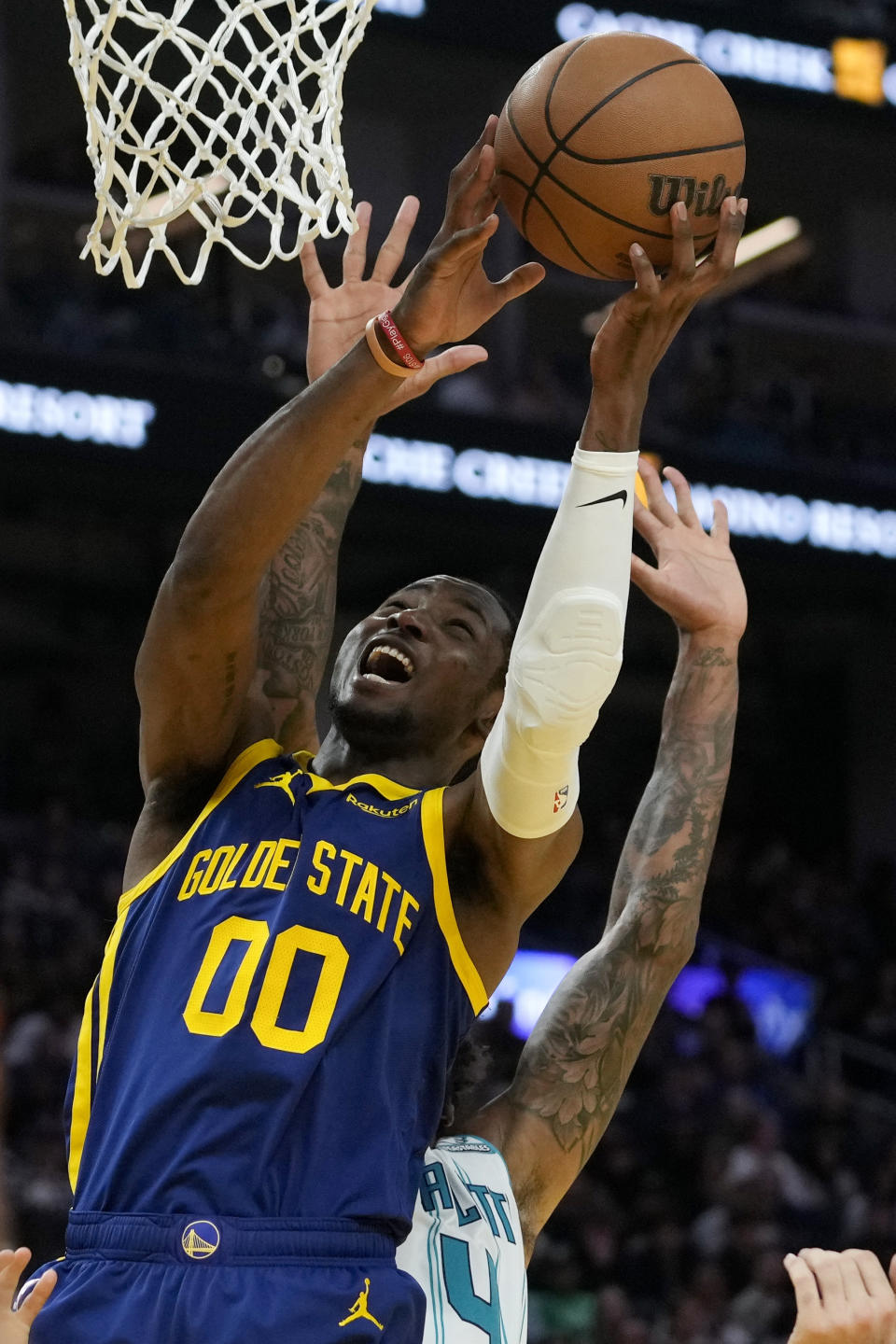 Golden State Warriors forward Jonathan Kuminga (00) shoots against the Charlotte Hornets during the first half of an NBA basketball game Friday, Feb. 23, 2024, in San Francisco. (AP Photo/Godofredo A. Vásquez)