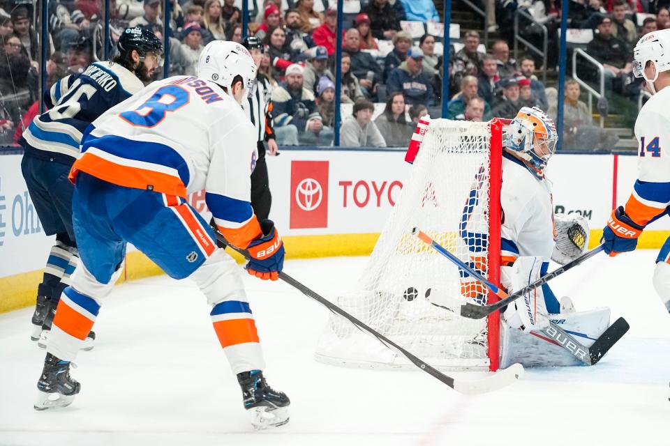 Apr 4, 2024; Columbus, Ohio, USA; Columbus Blue Jackets right wing Kirill Marchenko (86) scores a goal from behind New York Islanders goaltender Ilya Sorokin (30) during the first period of the NHL hockey game at Nationwide Arena.