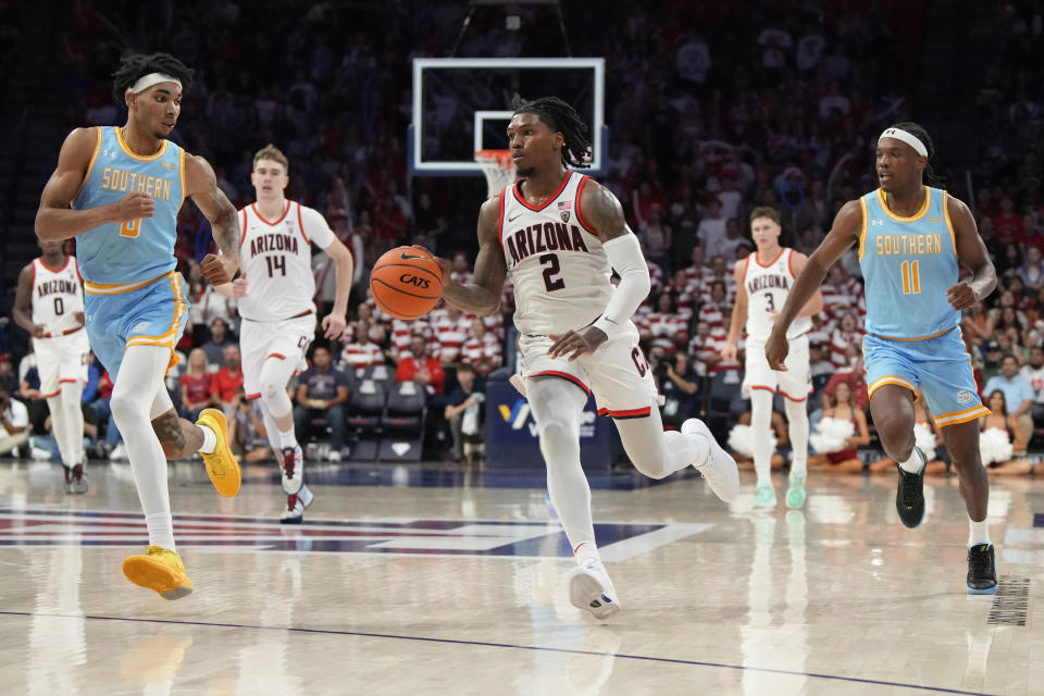 Arizona guard Caleb Love (2) drives between Southern University forward Brentay Noel (0) and guard Jordan Johnson (11) during the second half of an NCAA college basketball game, Monday, Nov. 13, 2023, in Tucson, Ariz. (AP Photo/Rick Scuteri)