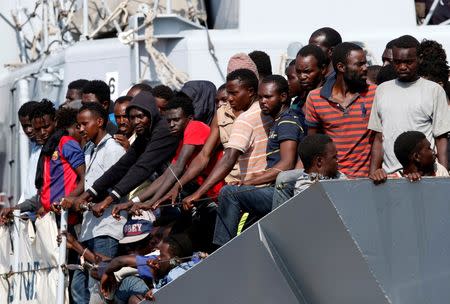 Migrants wait to disembark from the Italian Navy vessel Sfinge in the Sicilian harbour of Pozzallo, southern Italy, August 31, 2016. REUTERS/ Antonio Parrinello