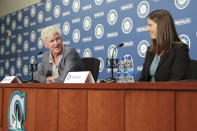 Catie Griggs, right, is introduced as the Seattle Mariners' new president of business operations by John Stanton, the team's chairman and managing partner, during a baseball a press conference on Wednesday, July 28, 2021, (AP Photo/Jason Redmond)