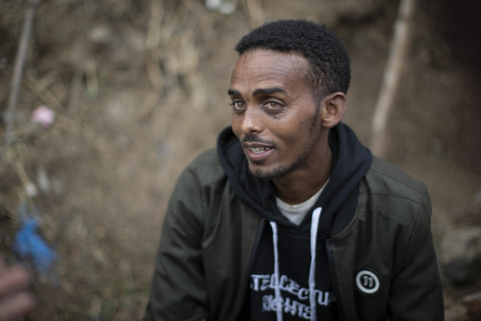 Clothes trader Gashaw Asmare, 22, who says he is striving for the kind of national unity that Ethiopia needs, speaks to The Associated Press in Gondar, in the Amhara region of Ethiopia Sunday, May 2, 2021. Ethiopia faces a growing crisis of ethnic nationalism that some fear could tear Africa's second most populous country apart, six months after the government launched a military operation in the Tigray region to capture its fugitive leaders. (AP Photo/Ben Curtis)