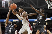 Arkansas guard JD Notae, center, fights for a rebound against Texas A&M's Wade Taylor IV (4) and Hassan Diarra (5) during the first half of an NCAA college basketball game Saturday, Jan. 22, 2022, in Fayetteville, Ark. (AP Photo/Michael Woods)