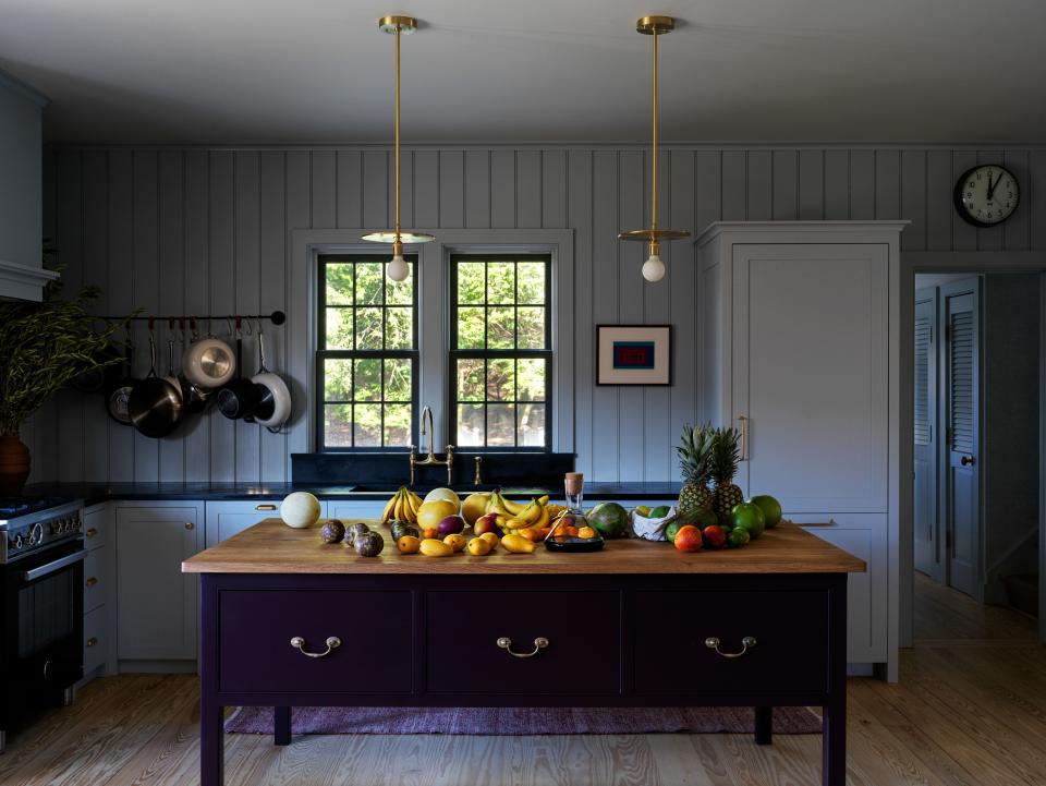 The kitchen’s plain english island, Bertazzoni range, and Workstead pendants.