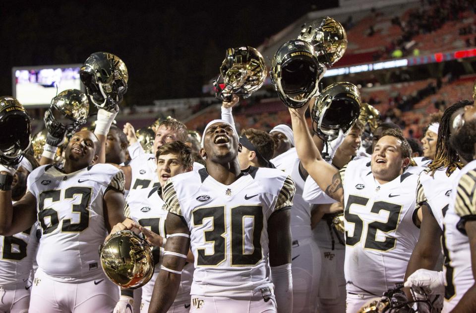 Wake Forest's Ja'Cquez Williams (30) celebrates with his team after defeating North Carolina State in an NCAA college football game in Raleigh, N.C., Thursday, Nov. 8, 2018. (AP Photo/Ben McKeown)