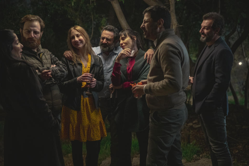 This photo released by Netflix shows characters from the Arabic-language version of the Italian film “Perfect Strangers,” about friends who agree to share their incoming calls, voice and text messages with each other over a dinner party, leading to a series of revelations that test their marriages and friendships. The film’s release has led to a widespread debate in some Arabic-speaking societies, such as Egypt, where some have denounced it as a threat to family and religious values while others praised and defended it.(Rudy Bou Chebel/Netflix via AP)