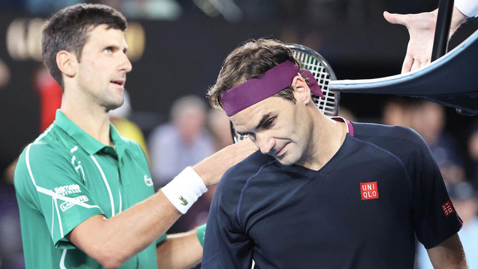 Novak Djokovic (pictured left) shakes hands with the umpire, while Roger Federer looks disappointed.