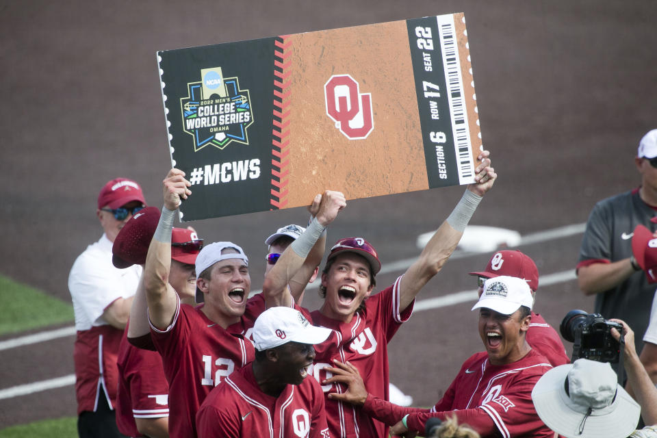 Oklahoma players celebrate their win over Virginia Tech in an NCAA college baseball super regional game Sunday, June 12, 2022, in Blacksburg, Va. (AP Photo/Scott P. Yates)