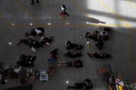 Anti-extradition bill protesters rest as the airport reopened a day after flights were halted due to a protest, at Hong Kong International Airport, China