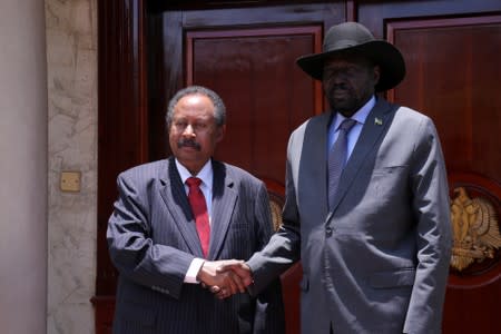 Sudan's prime minister Abdalla Hamdok and South Sudan's President Salva Kiir Mayardit shake hands during their meeting in Juba