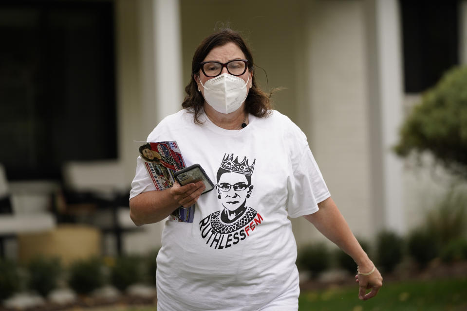 Lori Goldman canvasses in Troy, Mich., Thursday, Oct. 15, 2020. For most of her life, until 2016, Goldman had been politically apathetic. Had you offered her $1 million, she says, she could not have described the branches of government in any depth. She voted, sometimes. (AP Photo/Paul Sancya)