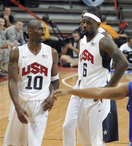 In this photo provided by the Las Vegas News Bureau, U.S. Olympic men's basketball team members Kobe Bryant and LeBron James react to a foul call during an exhibition game against the Dominican Republic in Las Vegas on Thursday, July 12, 2012. The United States won 113-59. (AP Photo/Las Vegas News Bureau, Brian Jones)