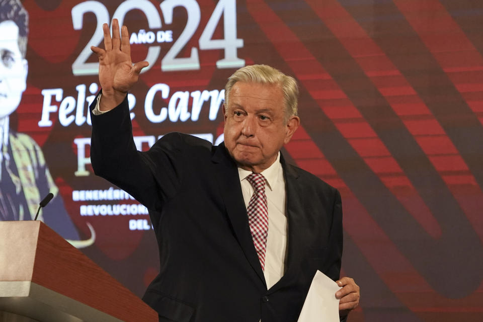 Mexican President Andres Manuel Lopez Obrador waves during his daily, morning press conference at the National Palace in Mexico City, Friday, March 1, 2024. (AP Photo/Marco Ugarte)