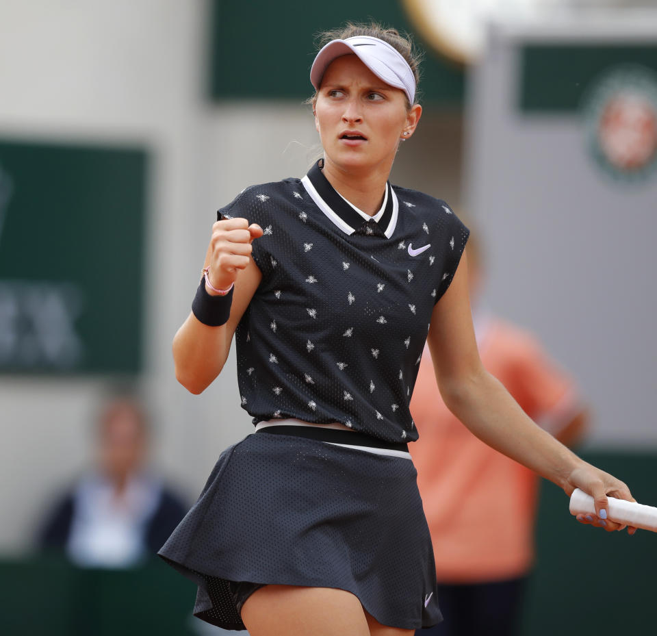 Marketa Vondrousova of the Czech Republic clenches her fist after scoring a point against Croatia's Petra Martic during their quarterfinal match of the French Open tennis tournament at the Roland Garros stadium in Paris, Tuesday, June 4, 2019. (AP Photo/Michel Euler)