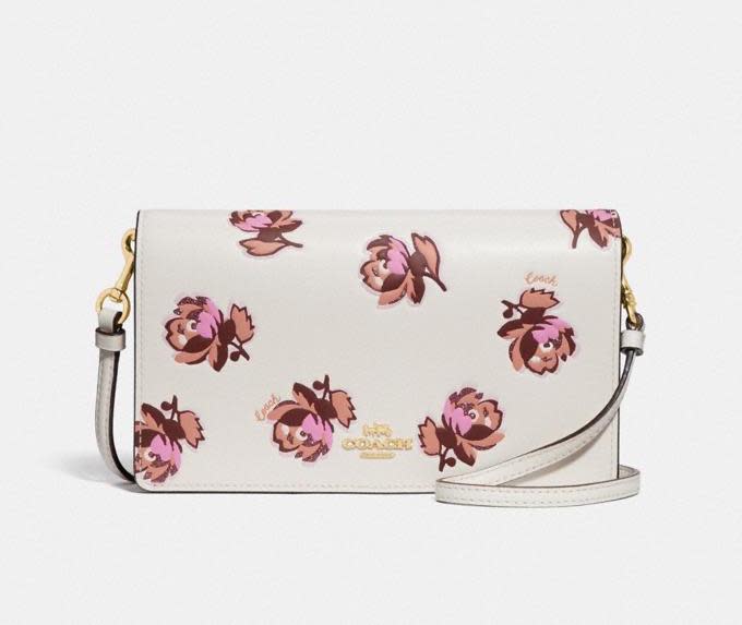 Hayden Foldover Crossbody Clutch With Floral Print. Image via Coach.