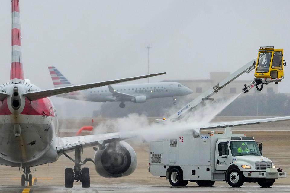 An American Airlines aircraft undergoes deicing procedures on Monday at Dallas/Fort Worth International Airport.