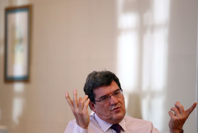 Spain's Social Security Minister, Escriva, gestures during an interview with Reuters at his ministry in Madrid