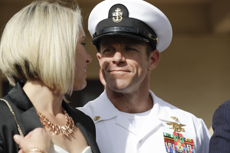 Navy Special Operations Chief Edward Gallagher, right, walks with his wife, Andrea Gallagher as they leave a military court on Naval Base San Diego, Tuesday, July 2, 2019, in San Diego. A military jury acquitted the decorated Navy SEAL Tuesday of murder in the killing of a wounded Islamic State captive under his care in Iraq in 2017. (AP Photo/Gregory Bull)