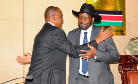 South Sudan's President Salva Kiir (R) embraces Taban Deng Gai after his swearing-in ceremony as First Vice President at the Presidential Palace in the capital of Juba, South Sudan, July 26, 2016. REUTERS/Jok Solomun