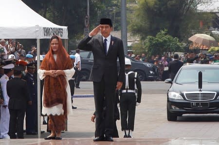 Indonesian President Joko Widodo salutes as he arrives to attend a funeral ceremony of former Indonesian President B.J. Habibie at Kalibata Heroes Cemetery complex in Jakarta