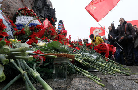 People lay flowers during a ceremony marking the 30th anniversary of the withdrawal of Soviet troops from Afghanistan at Victory Park, also known as Poklonnaya Gora War Memorial Park, in Moscow, Russia February 15, 2019. REUTERS/Shamil Zhumatov