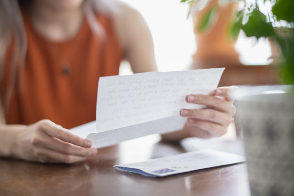 a person reading a letter