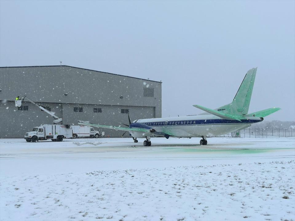 Deicer technicians apply a Type IV anti-icer, which prevents the formation of new ice, to an airplane. It is dyed green so technicians can see the coverage on the plane. A recent study shows that airplane deicers are polluting waterways near Milwaukee Mitchell International Airport with phosphorus.