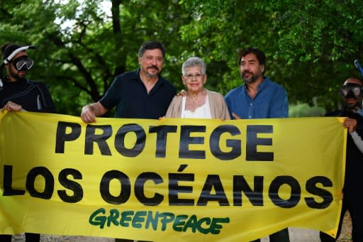 Spanish actress Pilar Bardem (C) and her sons Carlos (L) and Javier Bardem (R) stand behind a banner reading "Protect the Ocean" at a June 2019 Greenpeace event in Madrid to support a Global Ocean Treaty