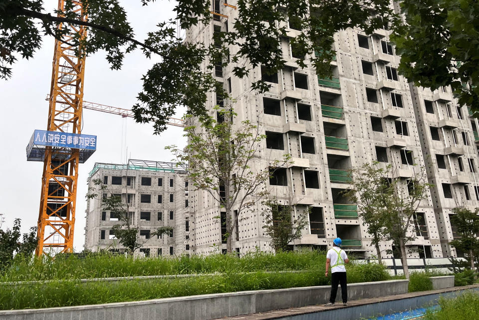 A worker looks at the construction site of Chinese developer Country Garden's residential buildings in Beijing, China, on August 11, 2023.  REUTERS/Tingshu Wang