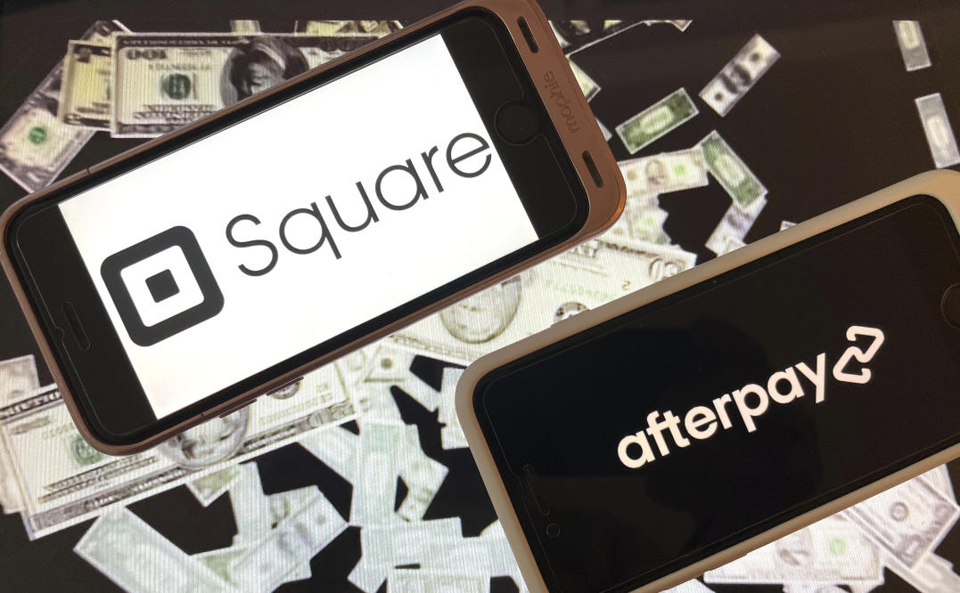 Afterpay logo displayed on a phone screen and Square logo displayed News  Photo - Getty Images