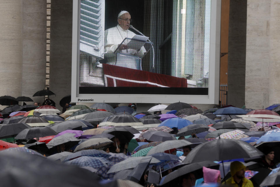 The image of Pope Francis is projected on a giant screen during the Angelus noon prayer he delivered from his studio's window overlooking St. Peter's Square at the Vatican, Sunday, Nov. 4, 2018. (AP Photo/Gregorio Borgia)