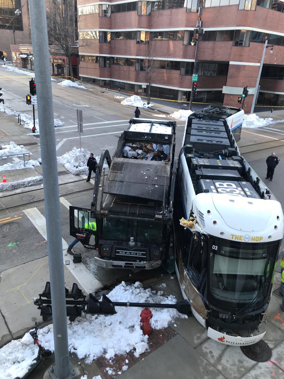 Hop streetcar service has temporarily been suspended after a garbage truck struck and derailed one of the streetcars near Milwaukee and Wells.