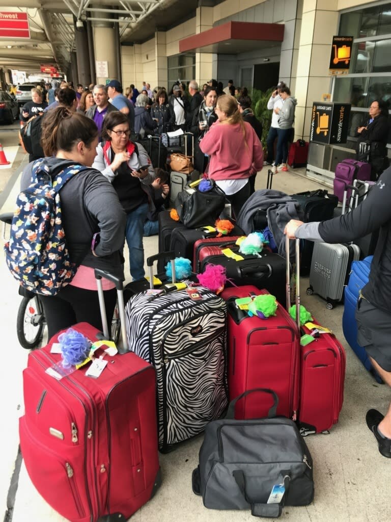 Crowds form at Louis Armstrong New Orleans International Airport after the remnants of Tropical Storm Olga knocked power out at the terminal early Saturday, Oct. 26, 2019. (David Grunfeld/The Times-Picayune/The New Orleans Advocate via AP)