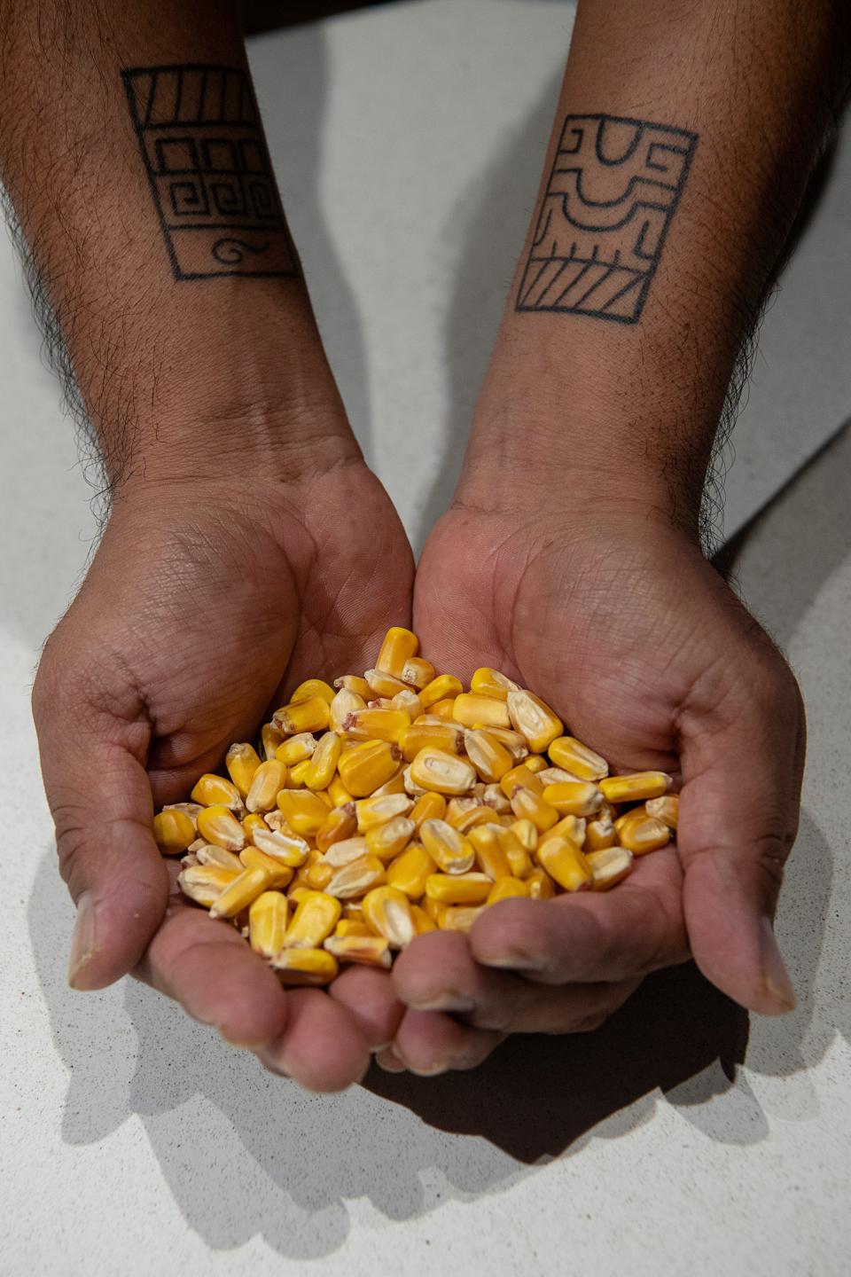 Luis Martinez holds a handful of heirloom corn, February 22, 2024.