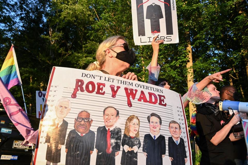 Demonstrators protest at the entrance of the gated community where US Supreme Court Justice Thomas Clarence lives in Fairfax, Virginia, after the US Supreme Court striked down the right to abortion on June 24, 2022. (Photo by ROBERTO SCHMIDT / AFP) (Photo by ROBERTO SCHMIDT/AFP via Getty Images)