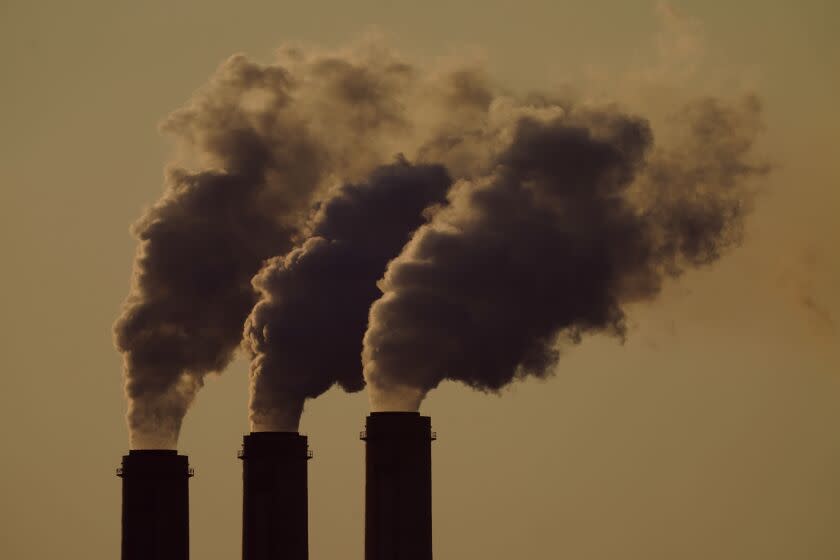 FILE - Emissions rise from the smokestacks at the Jeffrey Energy Center coal power plant as the suns sets, near Emmett, Kan., Sept. 18, 2021. The Environmental Protection Agency is proposing a federal plan that would restrict smokestack emissions from power plants and other industrial sources that burden downwind areas with air pollution they can't control. (AP Photo/Charlie Riedel, File)