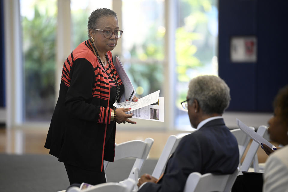 Daisy Grimes, left, CEO of the Volusia County African American Leadership Council, hands out information to attendees during the Voters Education 2024 Community Forum, addressing the Florida Legislature's voter suppression tactics, Thursday, May 16, 2024, in Daytona Beach, Fla. Laws passed in several Republican-controlled states are making it challenging for advocates to adapt as they try to register and educate potential voters with just months to go before the presidential election. (AP Photo/Phelan M. Ebenhack)