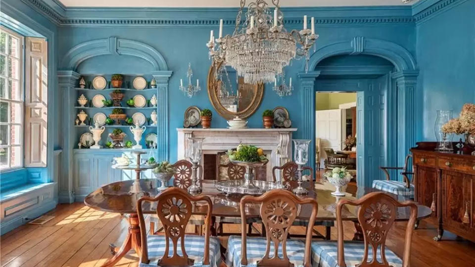 The dining room dressed in a pastel shade of blue. - Credit: Realtor.com