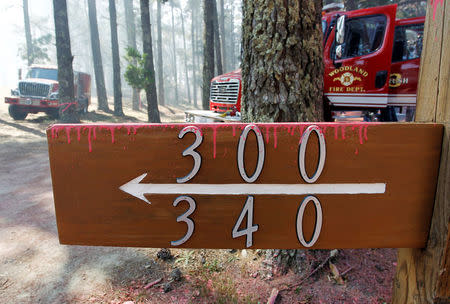 Dried fire retardant from an aerial tanker sticks to property numbers during the Soberanes Fire in the mountains above Carmel Highlands, California, U.S. July 28, 2016. REUTERS/Michael Fiala