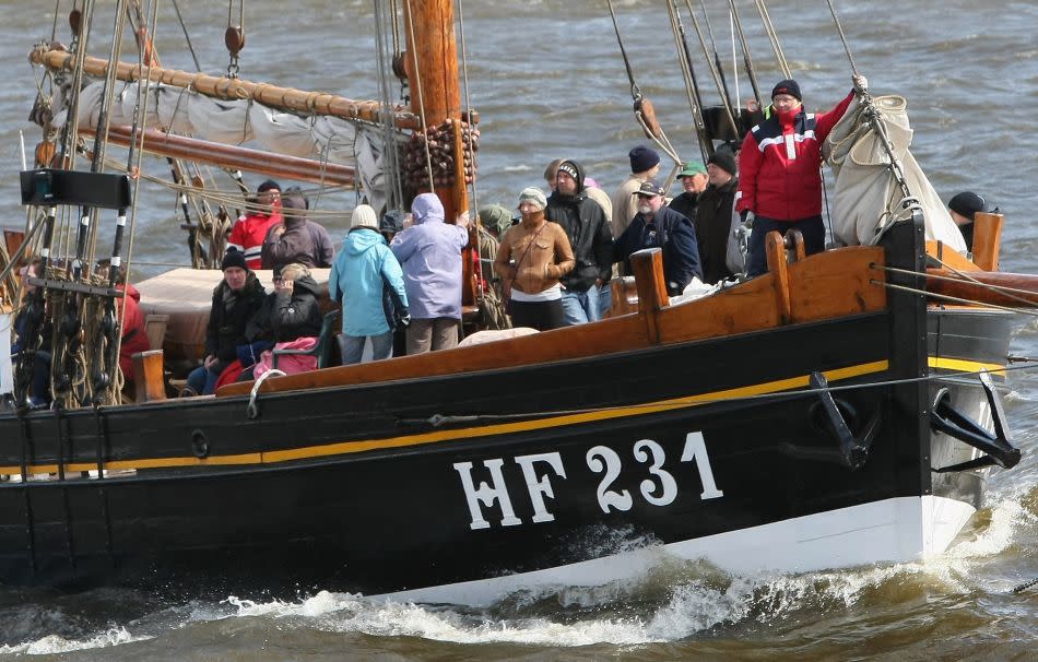 Passengers on a passing boat look on celebrations for the 823rd anniversary of the establishment of the port of Hamburg.