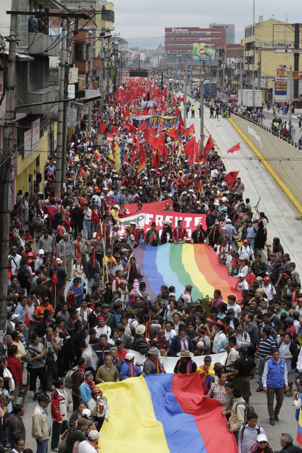 Indigenous people march to protest President Rafael Correa's policies on mining as they pass near the National Assembly in Quito, Ecuador, Thursday, March 22, 2012. Protesters reached Ecuador's capital on Thursday after a two-week march from the Amazon to oppose plans for large-scaling mining projects on their lands. (AP Photo/Dolores Ochoa)