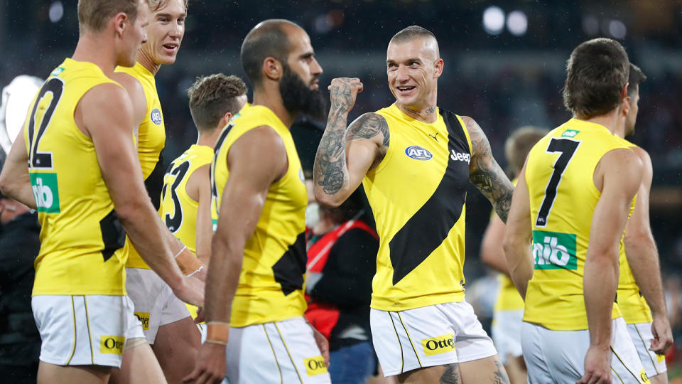 Dustin Martin and the Tigers are pictured walking from the field after their win over Port Adelaide in the AFL preliminary final.